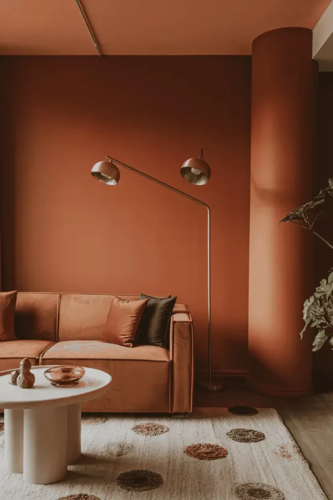 Cozy terracotta living room with golden lighting.